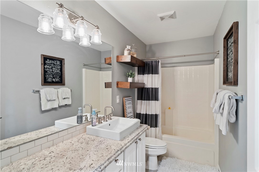 5042 Northeast 4th Place Renton, WA 98059 - Photo 19 of 29 a bathroom with a sink a toilet and shower