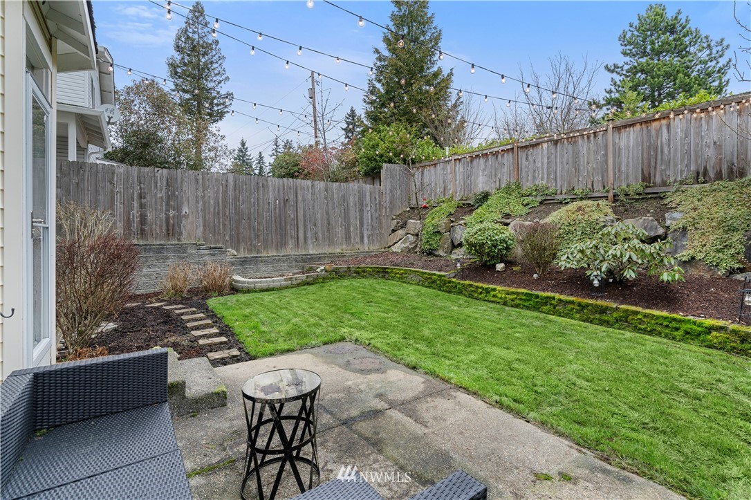 5042 Northeast 4th Place Renton, WA 98059 - Photo 21 of 29 a view of a backyard with furniture and a garden