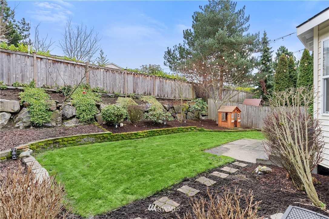 5042 Northeast 4th Place Renton, WA 98059 - Photo 23 of 29 a view of a backyard with plants and large tree