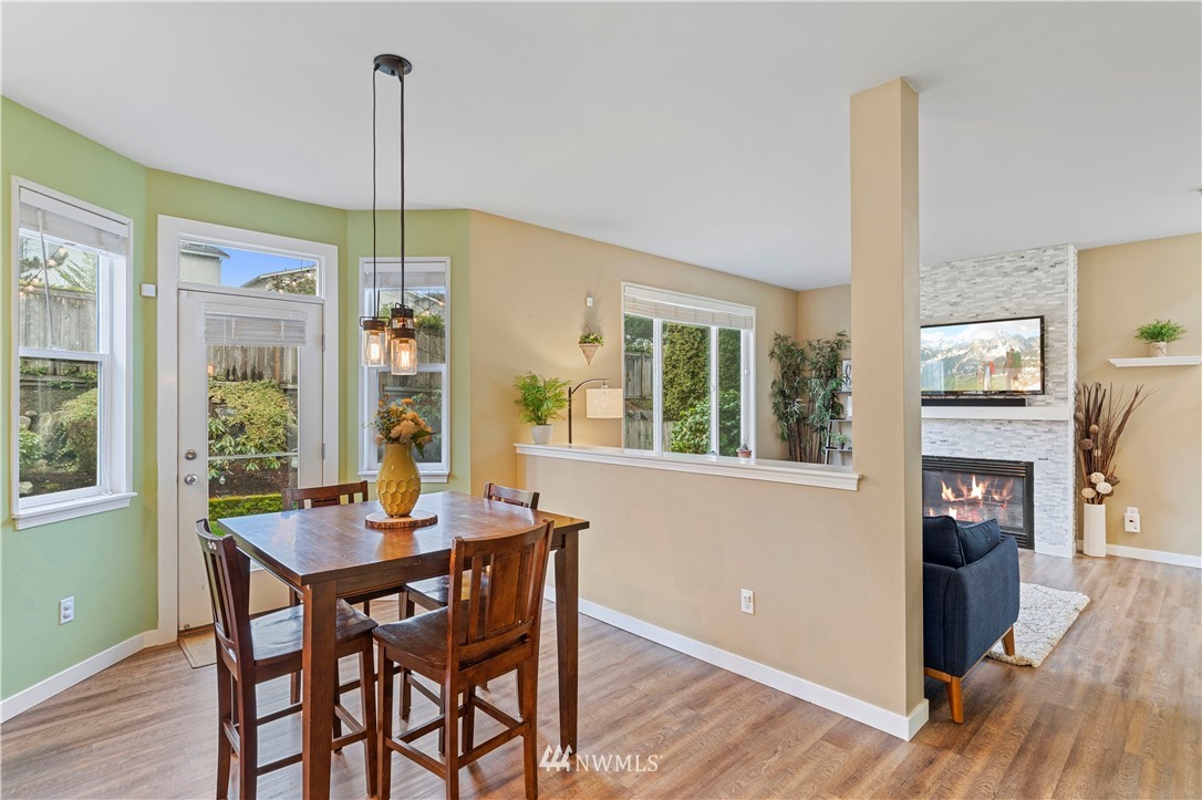5042 Northeast 4th Place Renton, WA 98059 - Photo 6 of 29 a view of a dining room with furniture window and wooden floor