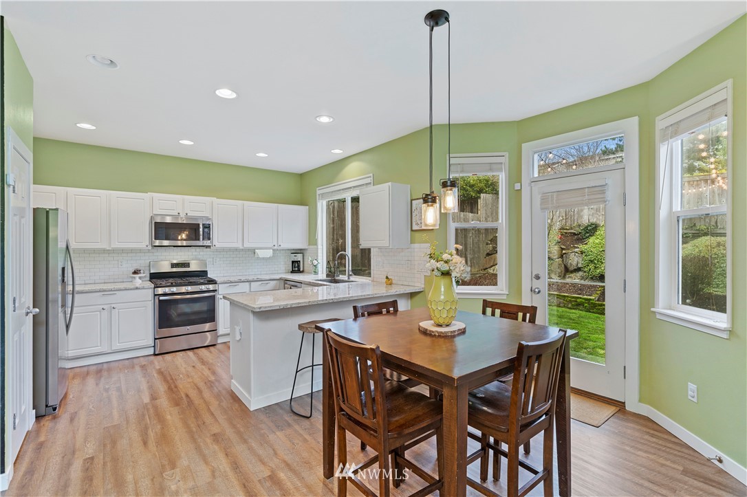 5042 Northeast 4th Place Renton, WA 98059 - Photo 8 of 29 a kitchen with a table chairs sink and cabinets