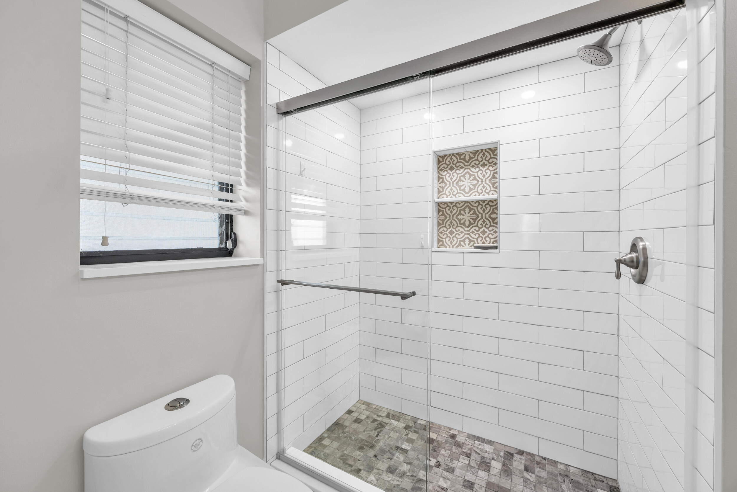 8 Southeast Turtle Creek Drive, Unit D Jupiter, FL 33469 - Photo 17 of 33 a bathroom with a shower
