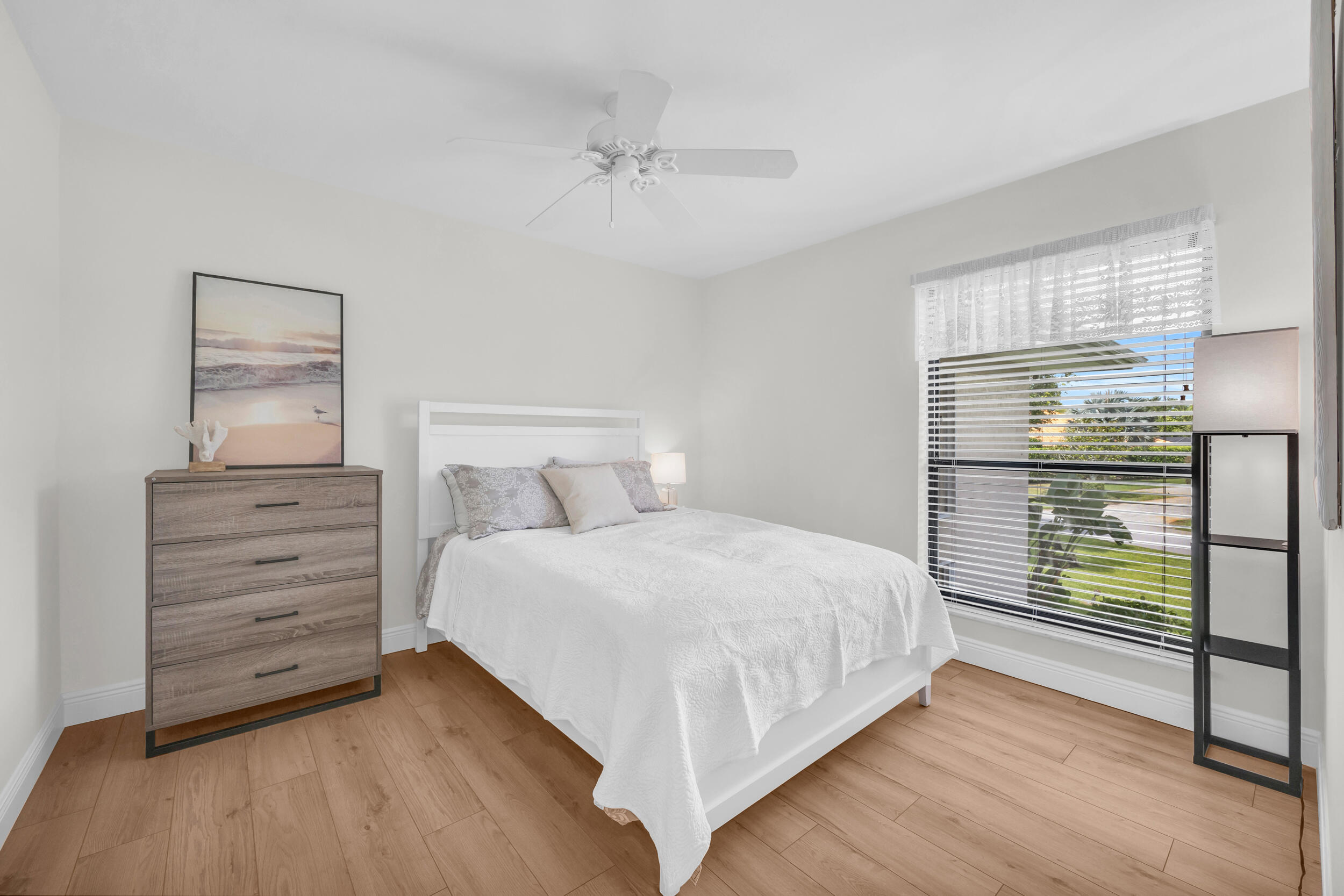 8 Southeast Turtle Creek Drive, Unit D Jupiter, FL 33469 - Photo 18 of 33 a bedroom with a bed and a window