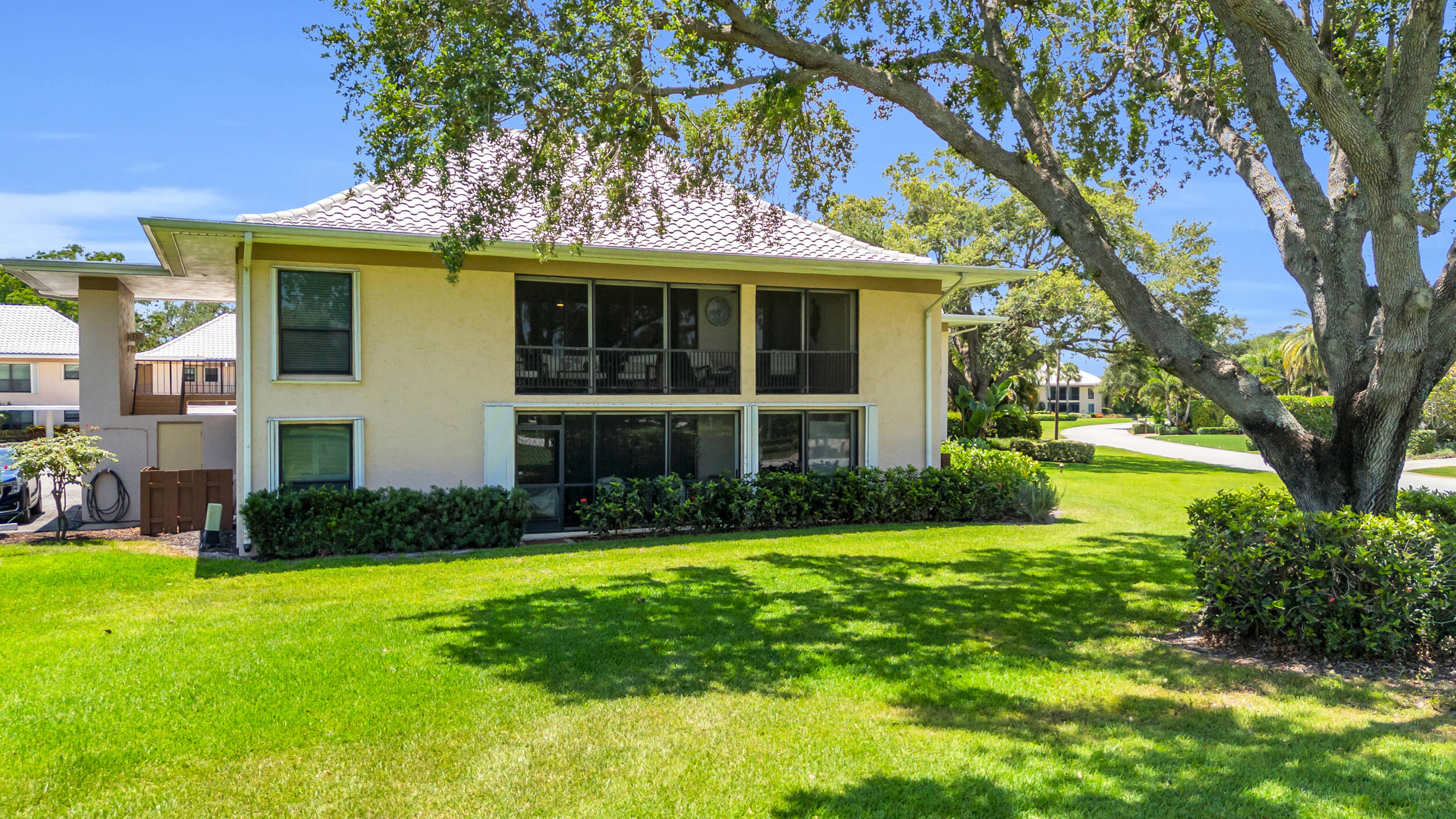 8 Southeast Turtle Creek Drive, Unit D Jupiter, FL 33469 - Photo 25 of 33 a view of a house with a yard and potted plants