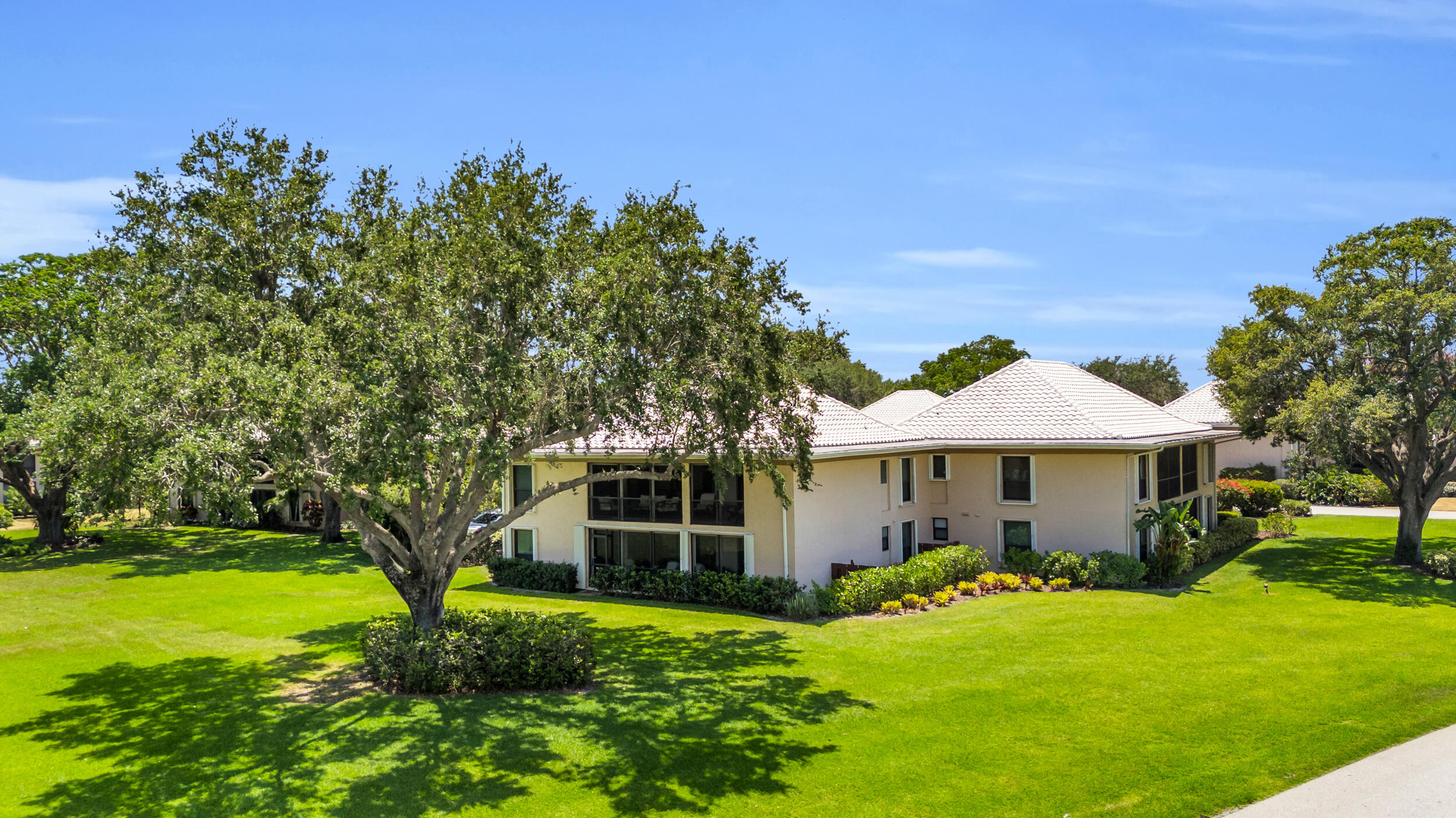 8 Southeast Turtle Creek Drive, Unit D Jupiter, FL 33469 - Photo 26 of 33 a front view of a house with garden