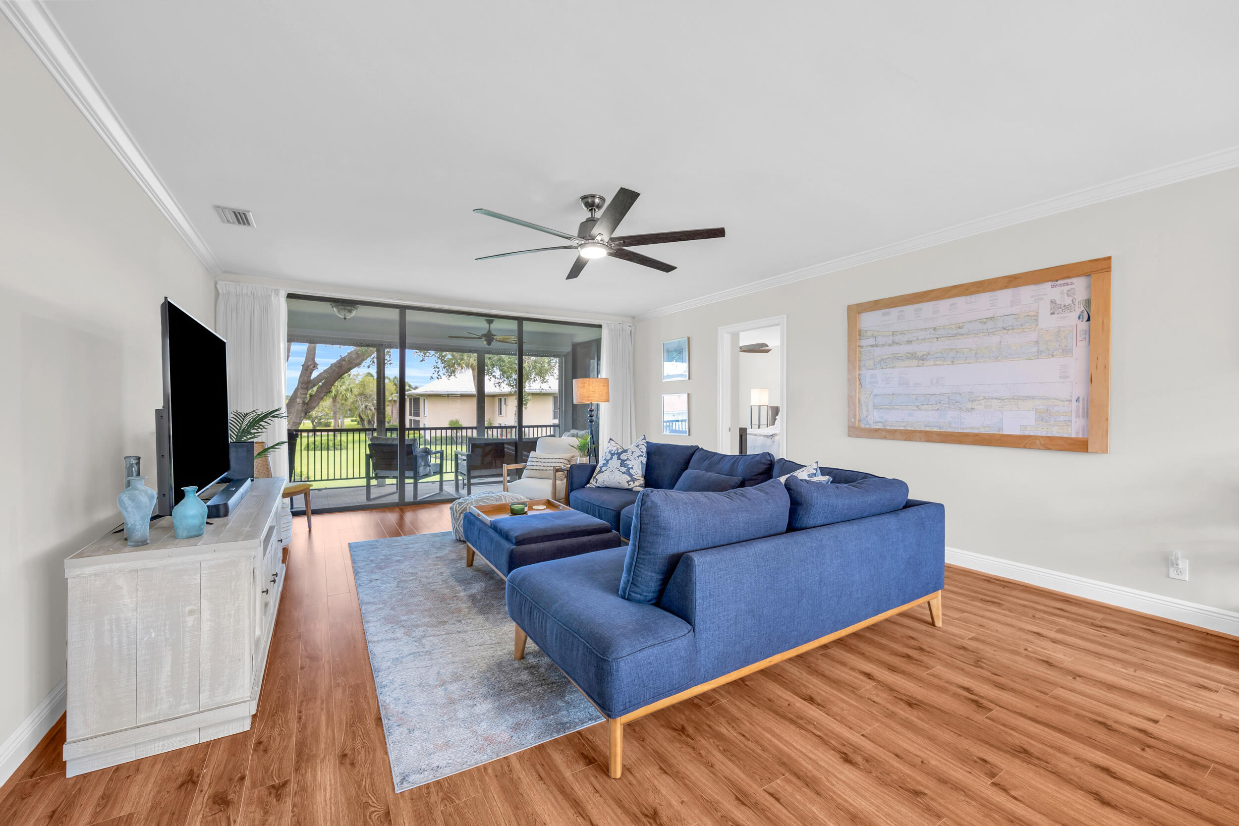 8 Southeast Turtle Creek Drive, Unit D Jupiter, FL 33469 - Photo 6 of 33 a living room with furniture and a flat screen tv