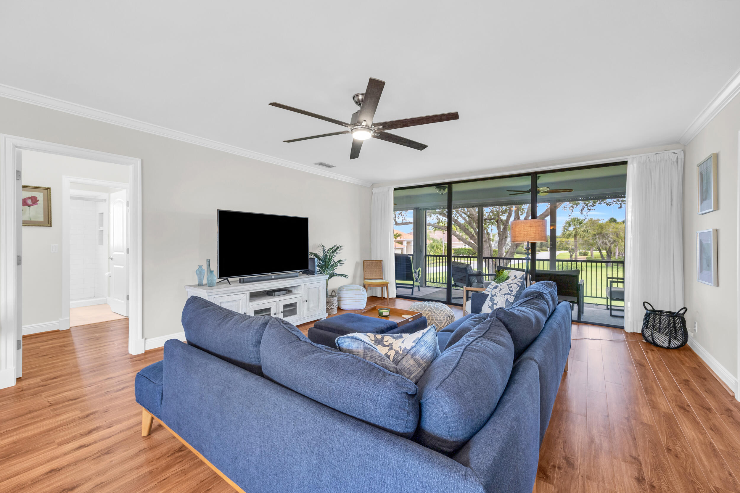 8 Southeast Turtle Creek Drive, Unit D Jupiter, FL 33469 - Photo 7 of 33 a living room with furniture and a flat screen tv