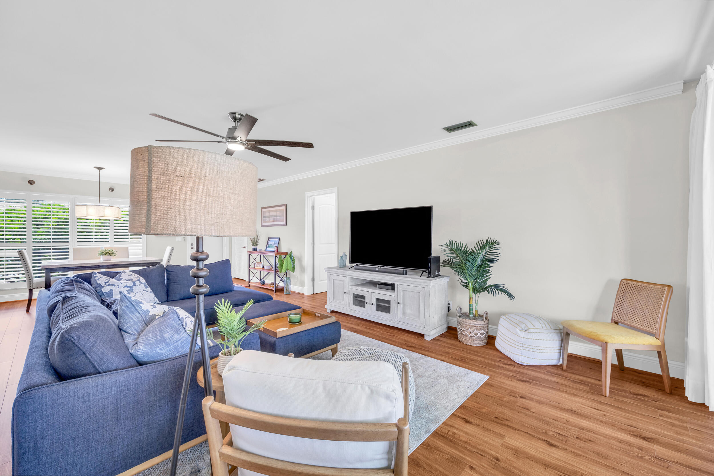 8 Southeast Turtle Creek Drive, Unit D Jupiter, FL 33469 - Photo 8 of 33 a living room with furniture and a flat screen tv