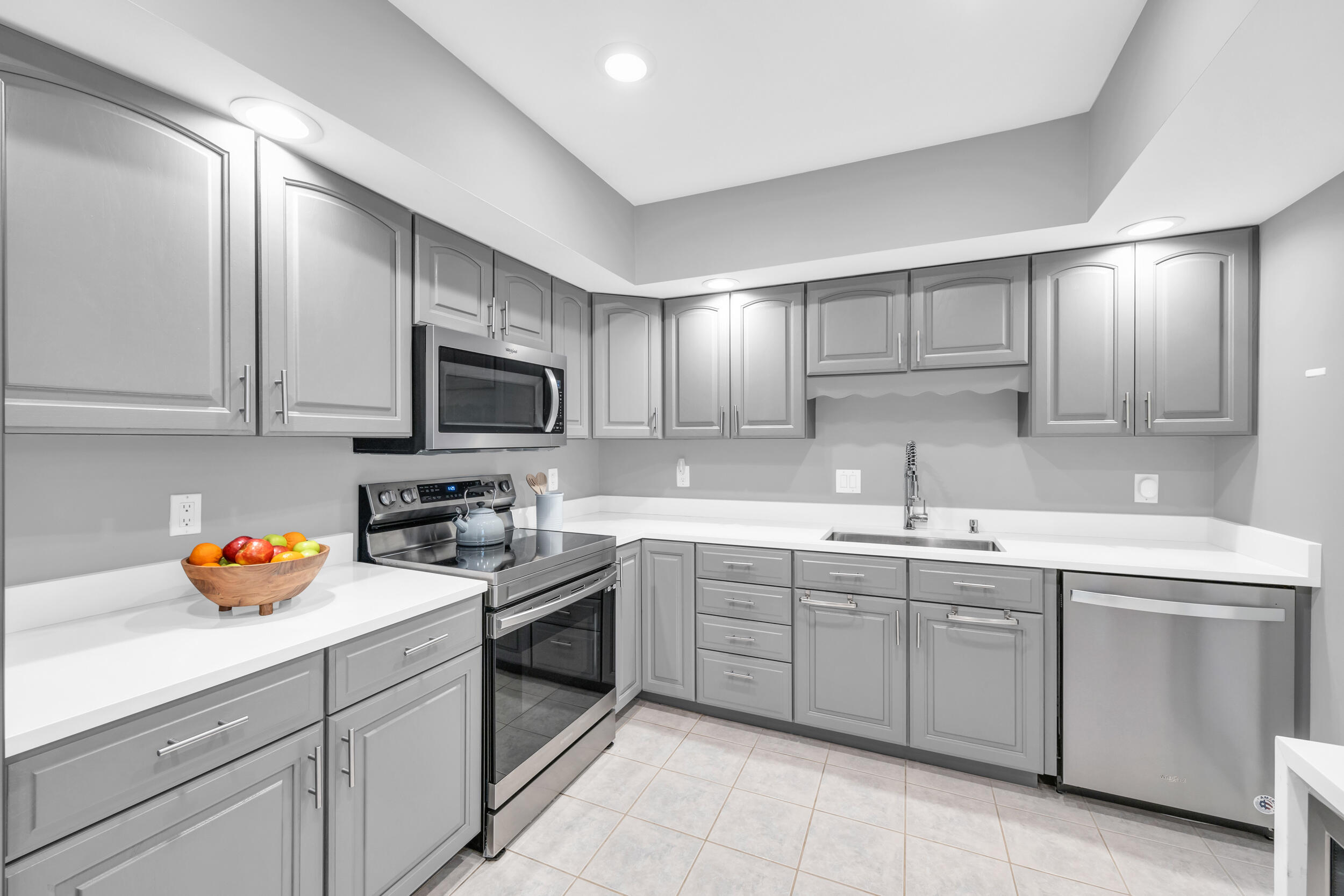 8 Southeast Turtle Creek Drive, Unit D Jupiter, FL 33469 - Photo 10 of 33 a kitchen with a sink a stove and cabinets