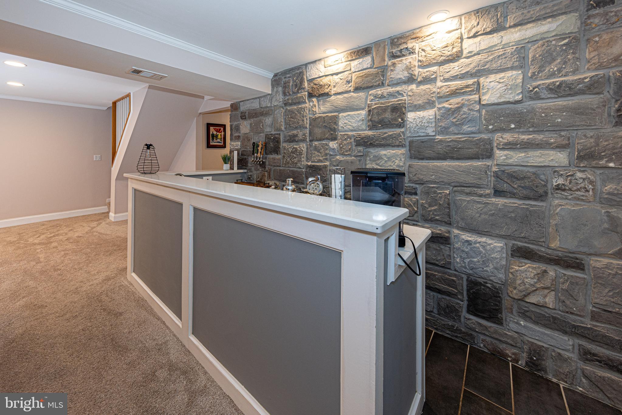 6404 Rivington Road Springfield, VA 22152 - Photo 27 of 49 Stone wall highlights the bar & the 4 beer taps!