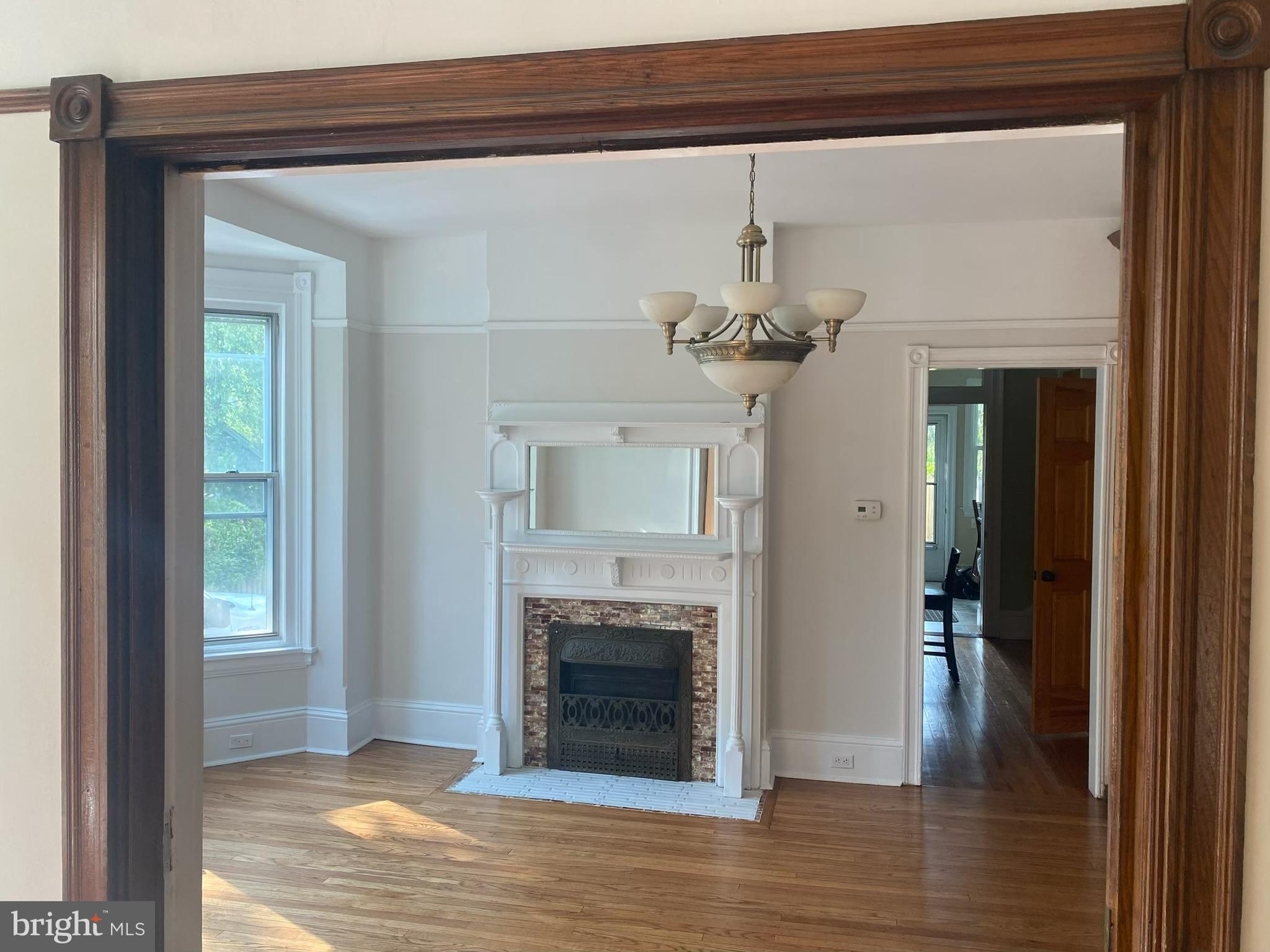 14 Simpson Road Ardmore, PA 19003 - Photo 14 of 58 a view of a livingroom with a fireplace wooden floor and a chandelier