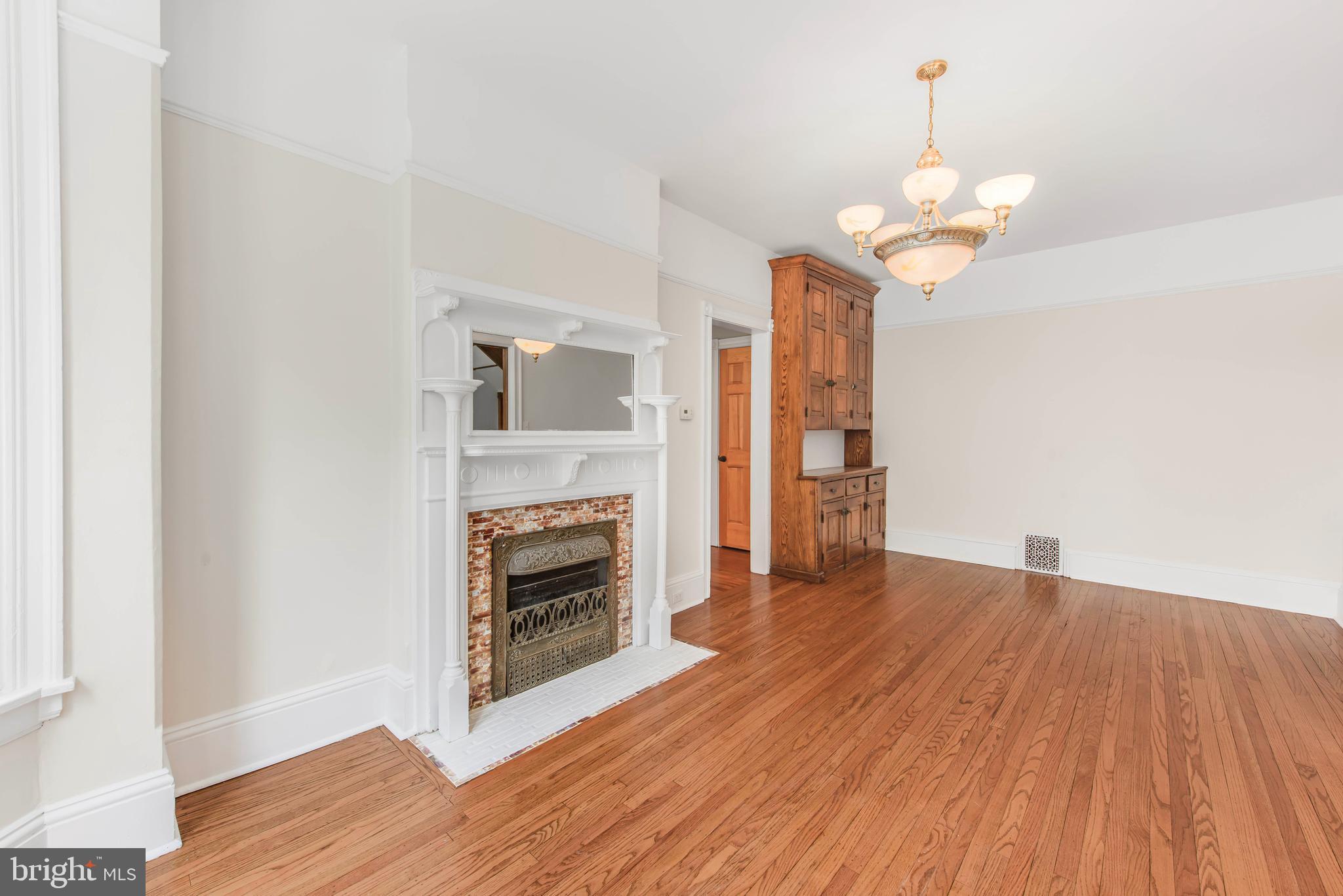 14 Simpson Road Ardmore, PA 19003 - Photo 17 of 58 a view of a livingroom with a fireplace a chandelier and wooden floor