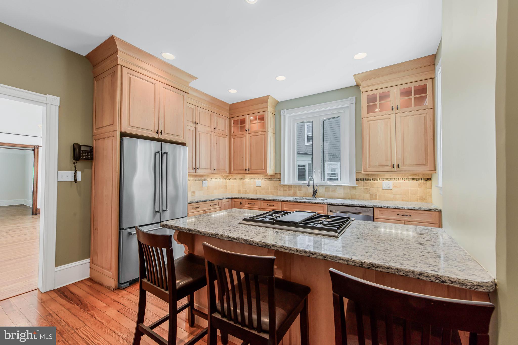 14 Simpson Road Ardmore, PA 19003 - Photo 21 of 58 a kitchen with stainless steel appliances granite countertop a stove refrigerator and cabinets