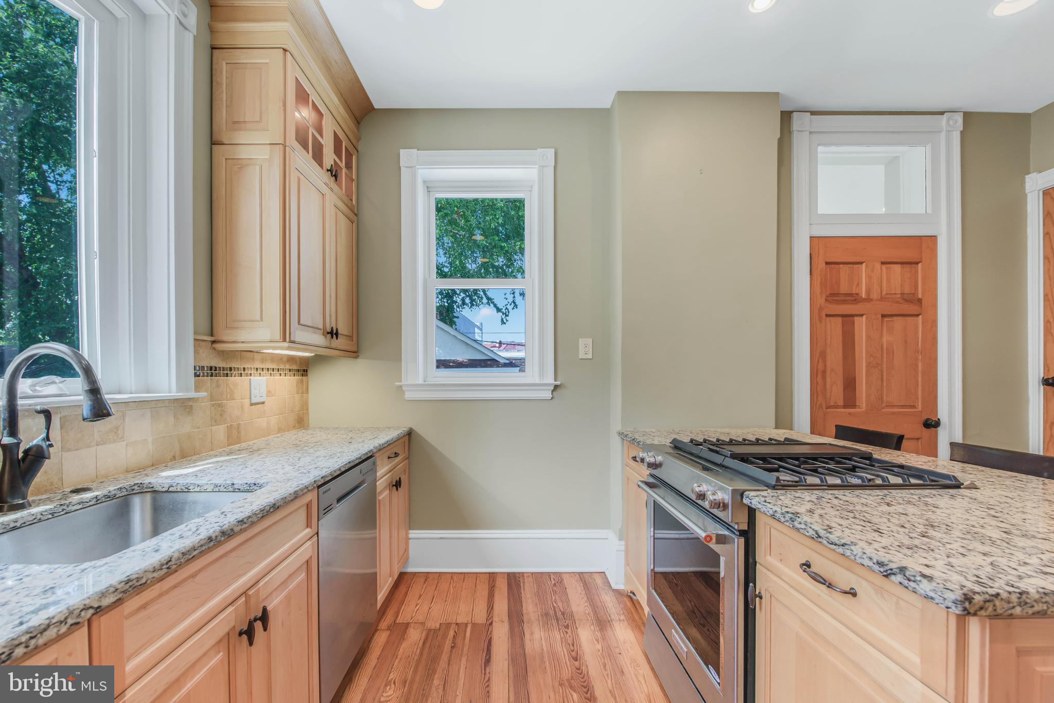 14 Simpson Road Ardmore, PA 19003 - Photo 23 of 58 a kitchen with granite countertop a sink stove and cabinets