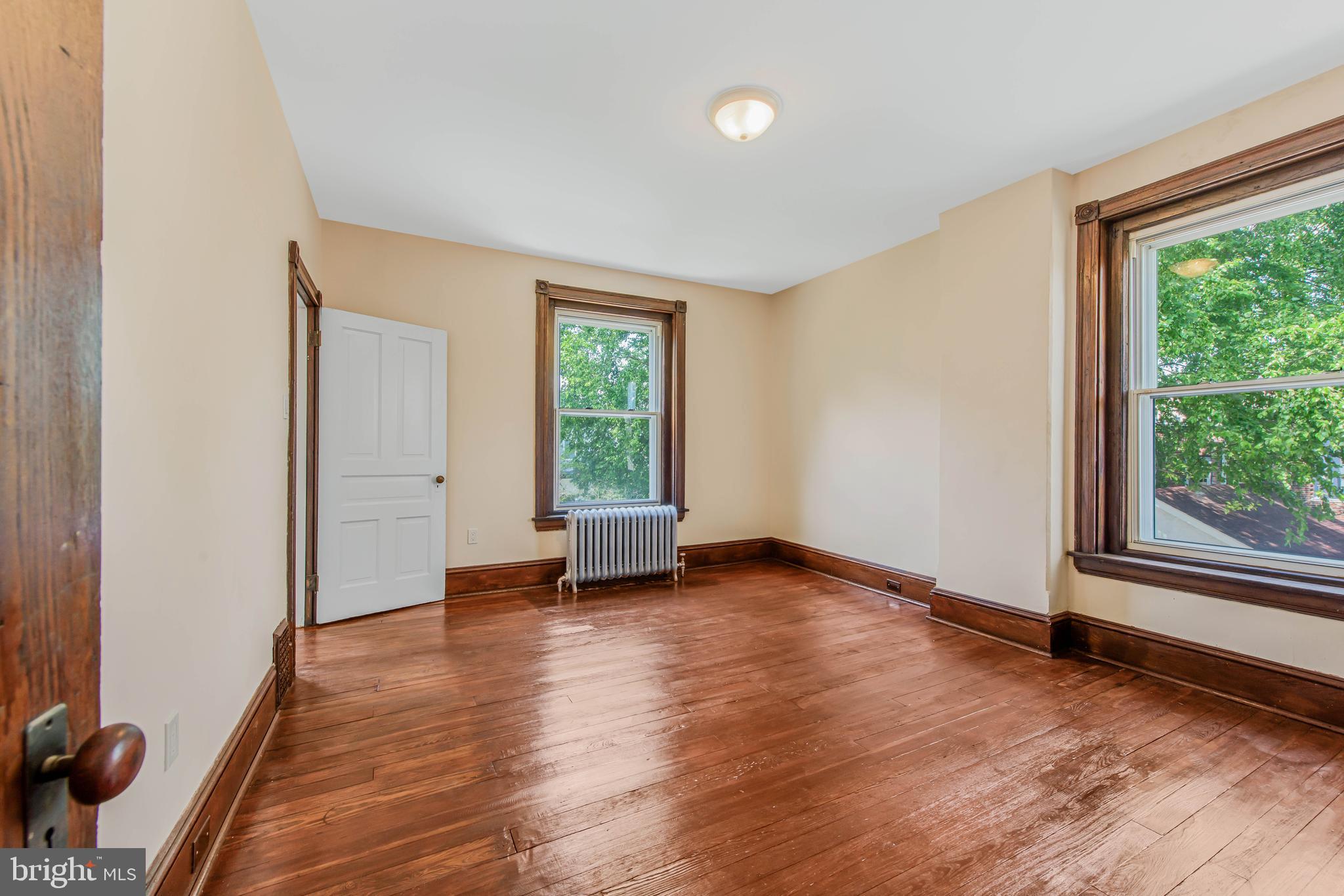 14 Simpson Road Ardmore, PA 19003 - Photo 47 of 58 an empty room with wooden floor and windows