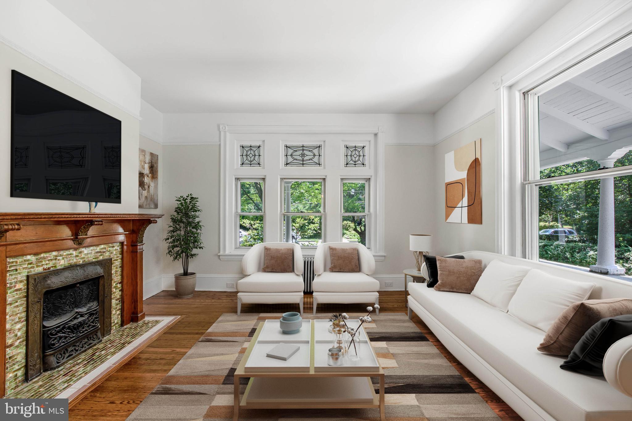 14 Simpson Road Ardmore, PA 19003 - Photo 10 of 58 a living room with furniture a flat screen tv and a fireplace
