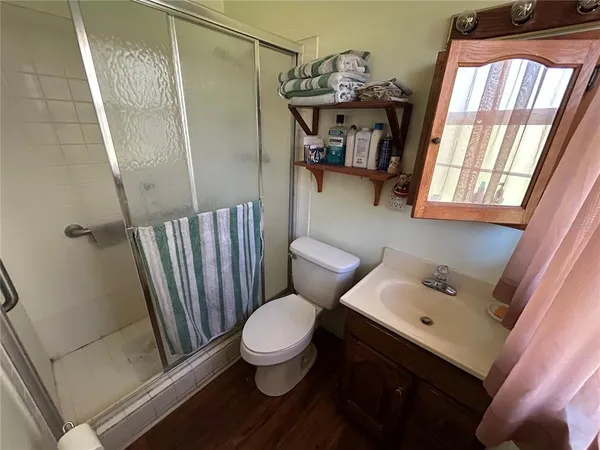 a bathroom with a sink toilet and shower