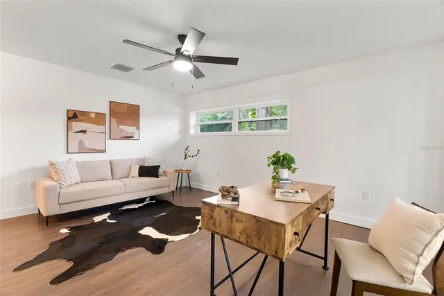 a living room with furniture and a lamp