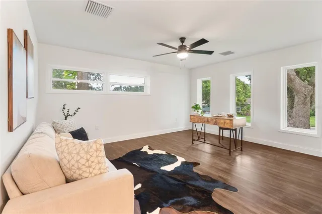 a living room with furniture and a wooden floor