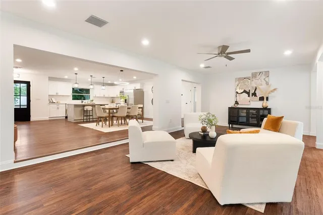 a living room with fireplace furniture and a wooden floor