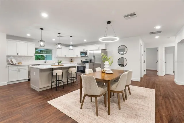 a large kitchen with a table and chairs in it