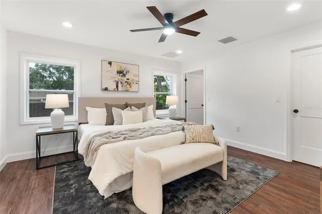 a bedroom with a large bed and a window