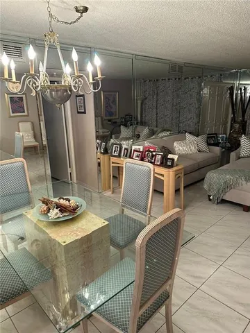 a dining room with furniture and a chandelier