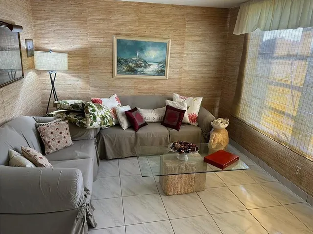 a living room with furniture and a rug