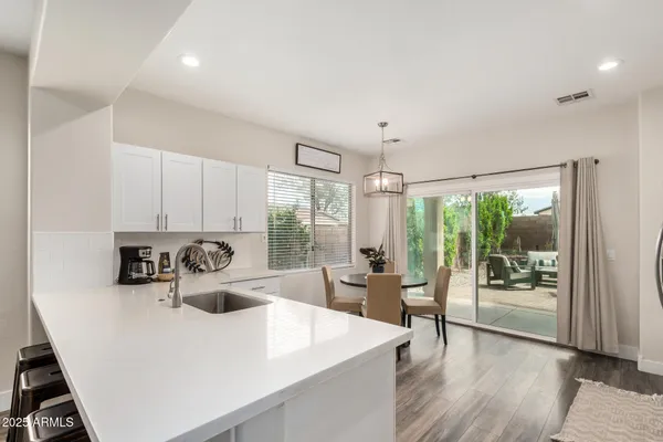 a view of a dining room with a table and chairs