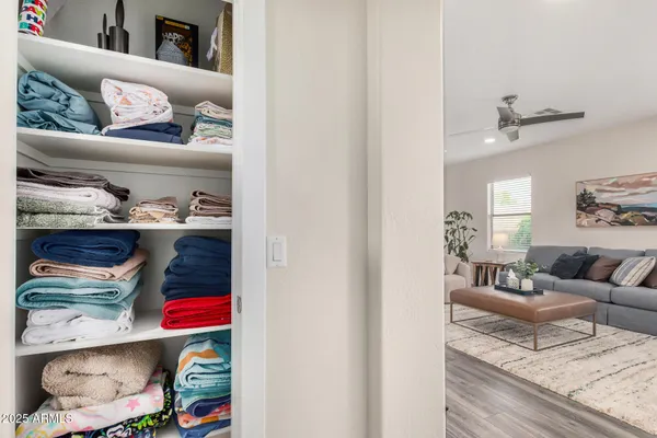 a living room with furniture and a shelf