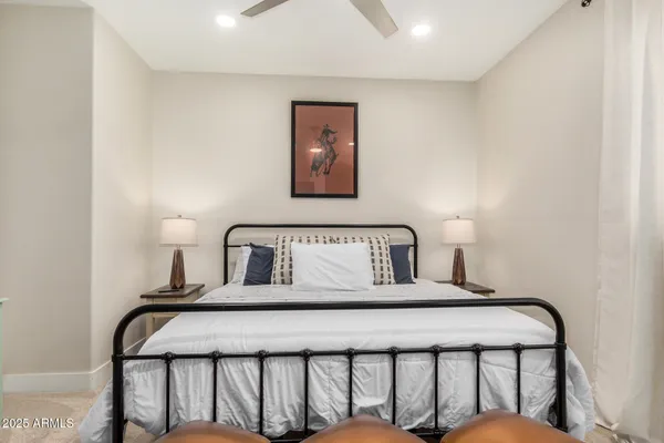 a bedroom with a bed and a lamp on table