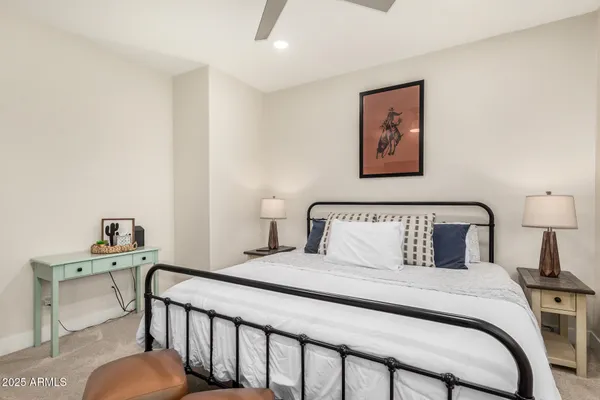 a bedroom with a bed and a lamp on table