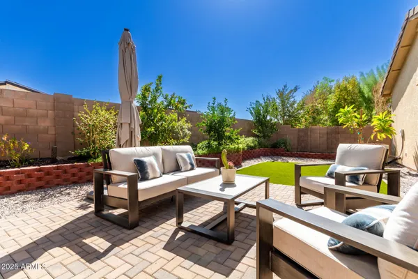 a view of a house with backyard and sitting area