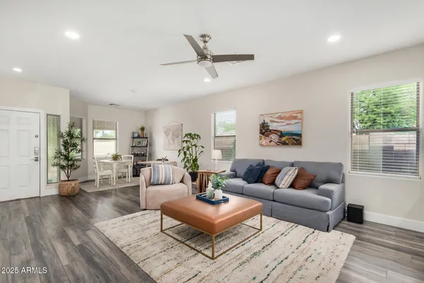 a living room with furniture and a wooden floor