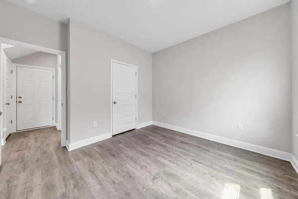 a view of an empty room and wooden floor