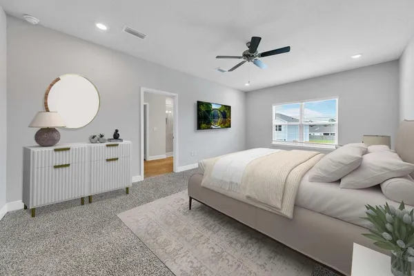 a bedroom with a large bed mirror and window