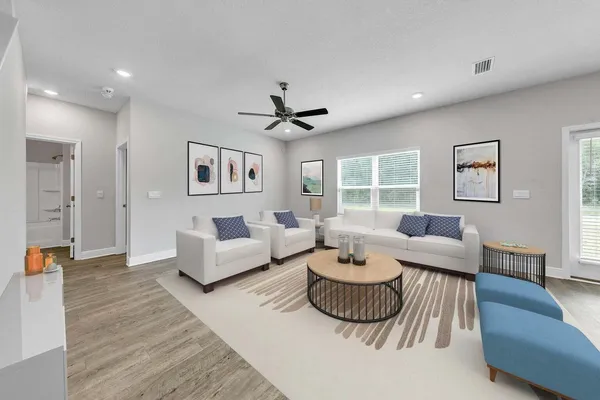 a living room with furniture and a large window