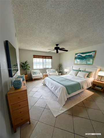 a bedroom with a bed a couch and dresser