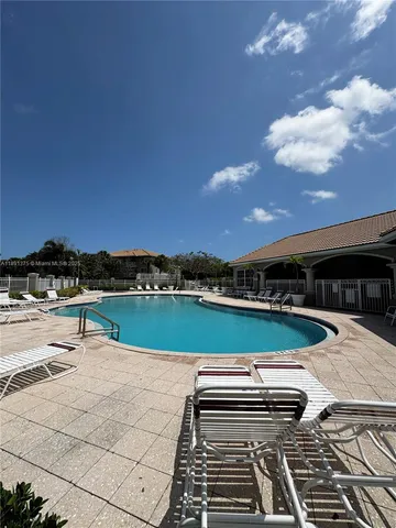 a view of a balcony with two chairs and a stove