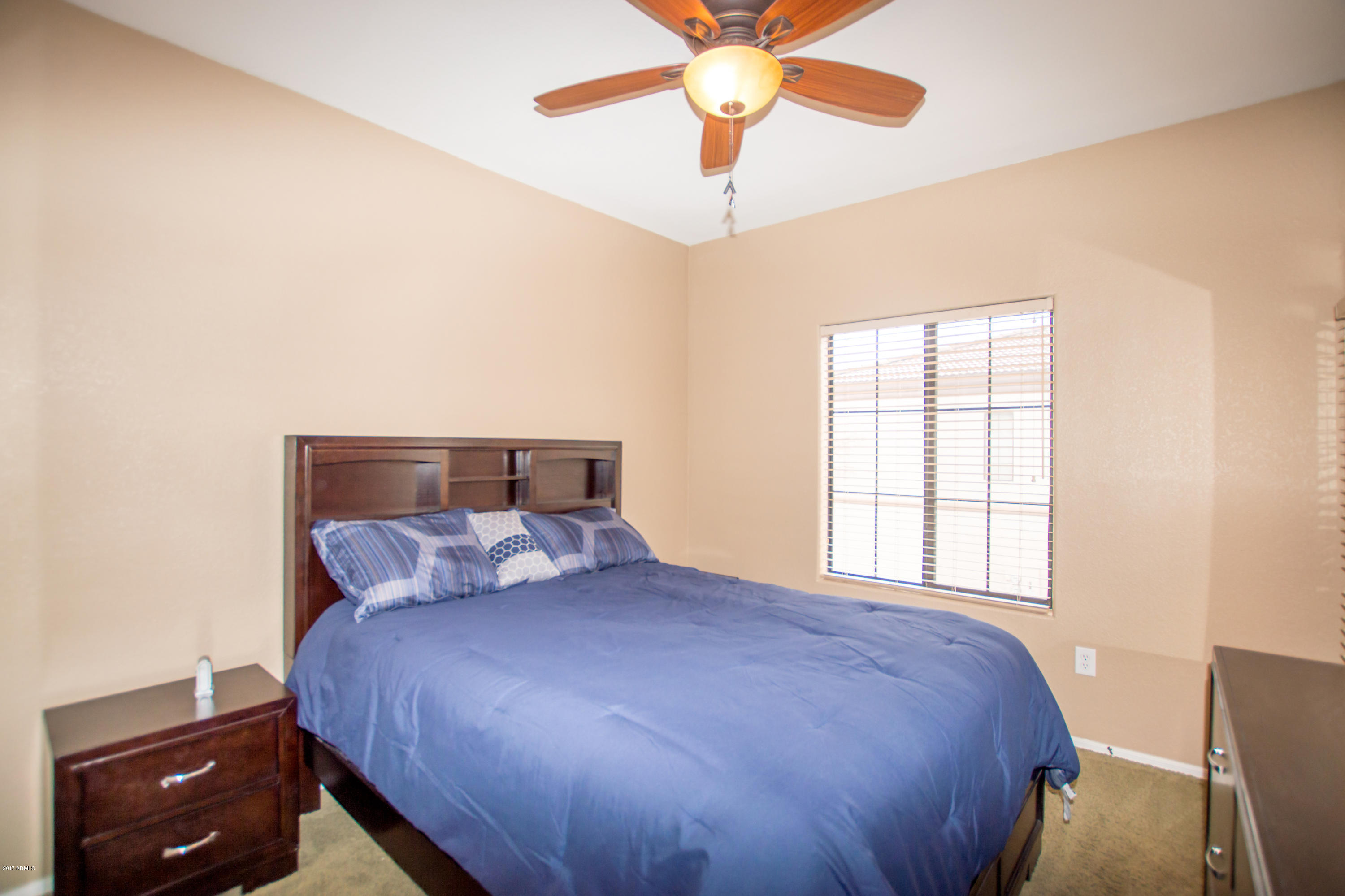 3150 East Beardsley Road, Unit 1016 Phoenix, AZ 85050 - Photo 16 of 25 a bedroom with a bed and a chandelier