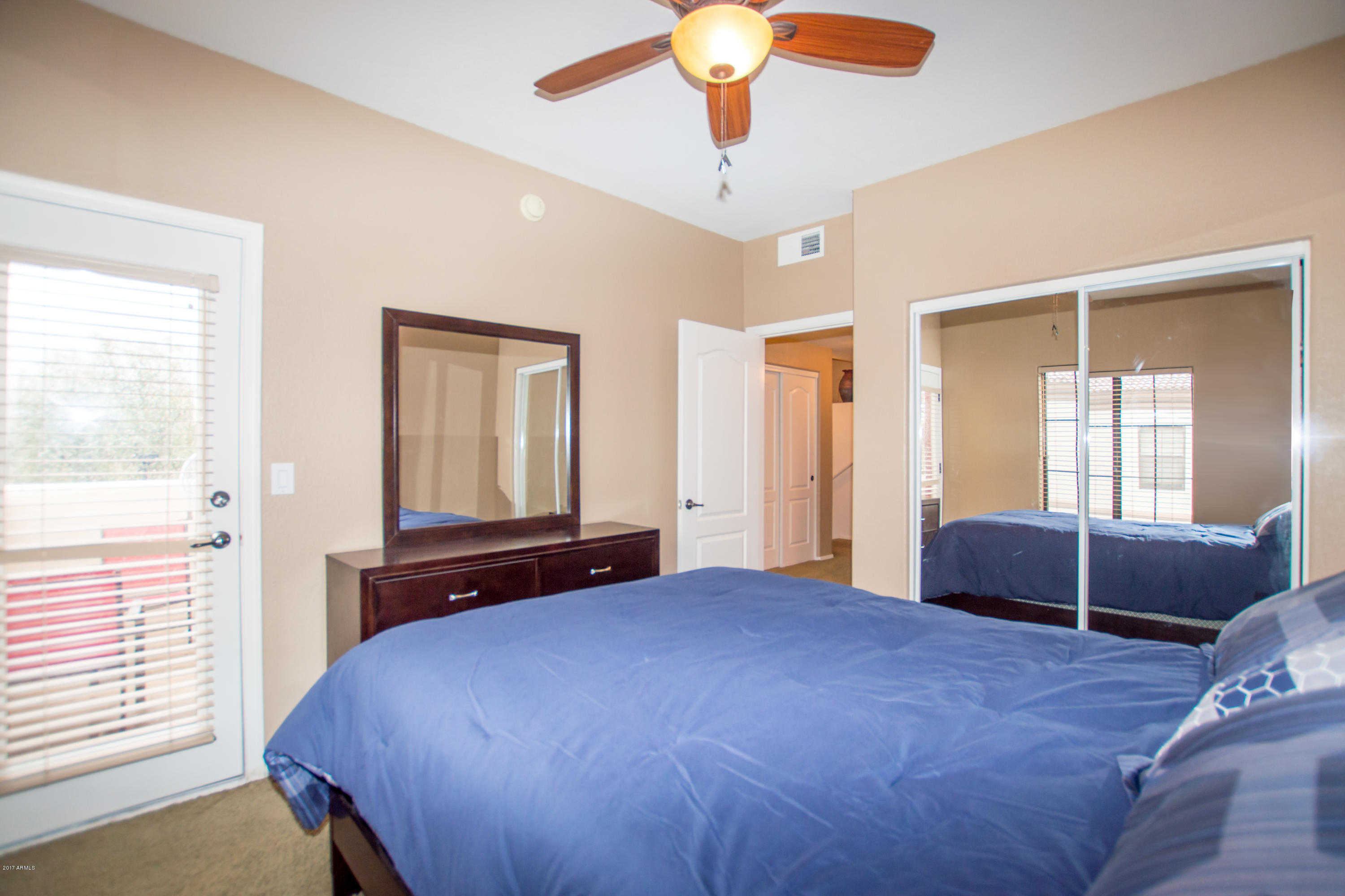 3150 East Beardsley Road, Unit 1016 Phoenix, AZ 85050 - Photo 17 of 25 a bedroom with a large bed and a large window