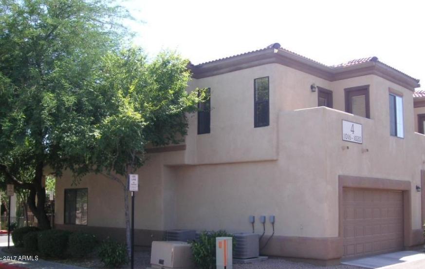 3150 East Beardsley Road, Unit 1016 Phoenix, AZ 85050 - Photo 20 of 25 a front view of a house with a tree