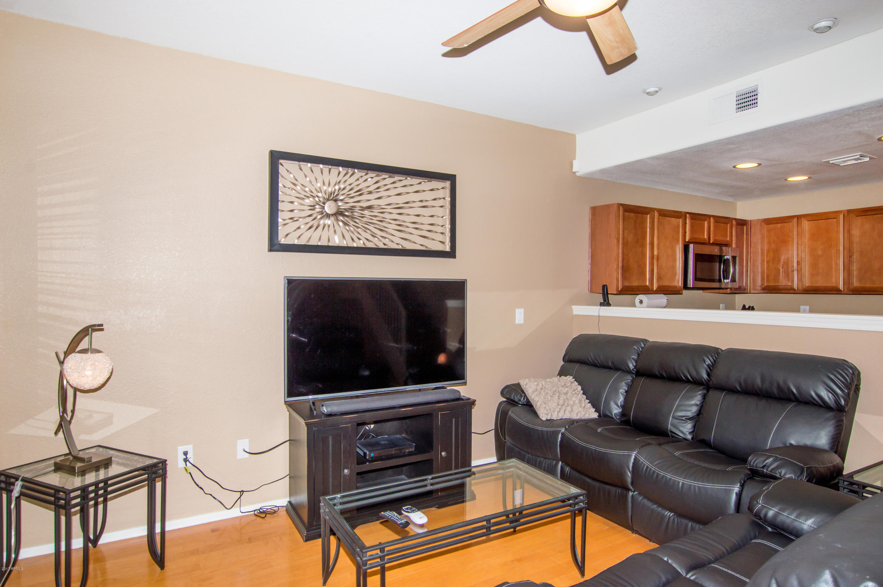 3150 East Beardsley Road, Unit 1016 Phoenix, AZ 85050 - Photo 2 of 25 a living room with furniture and a flat screen tv
