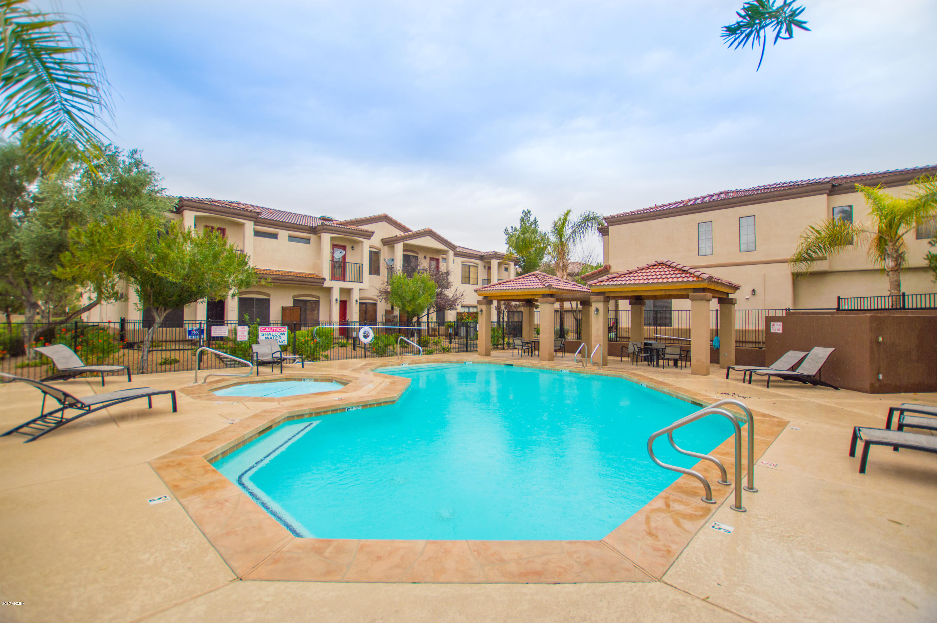 3150 East Beardsley Road, Unit 1016 Phoenix, AZ 85050 - Photo 22 of 25 a swimming pool with outdoor seating and yard