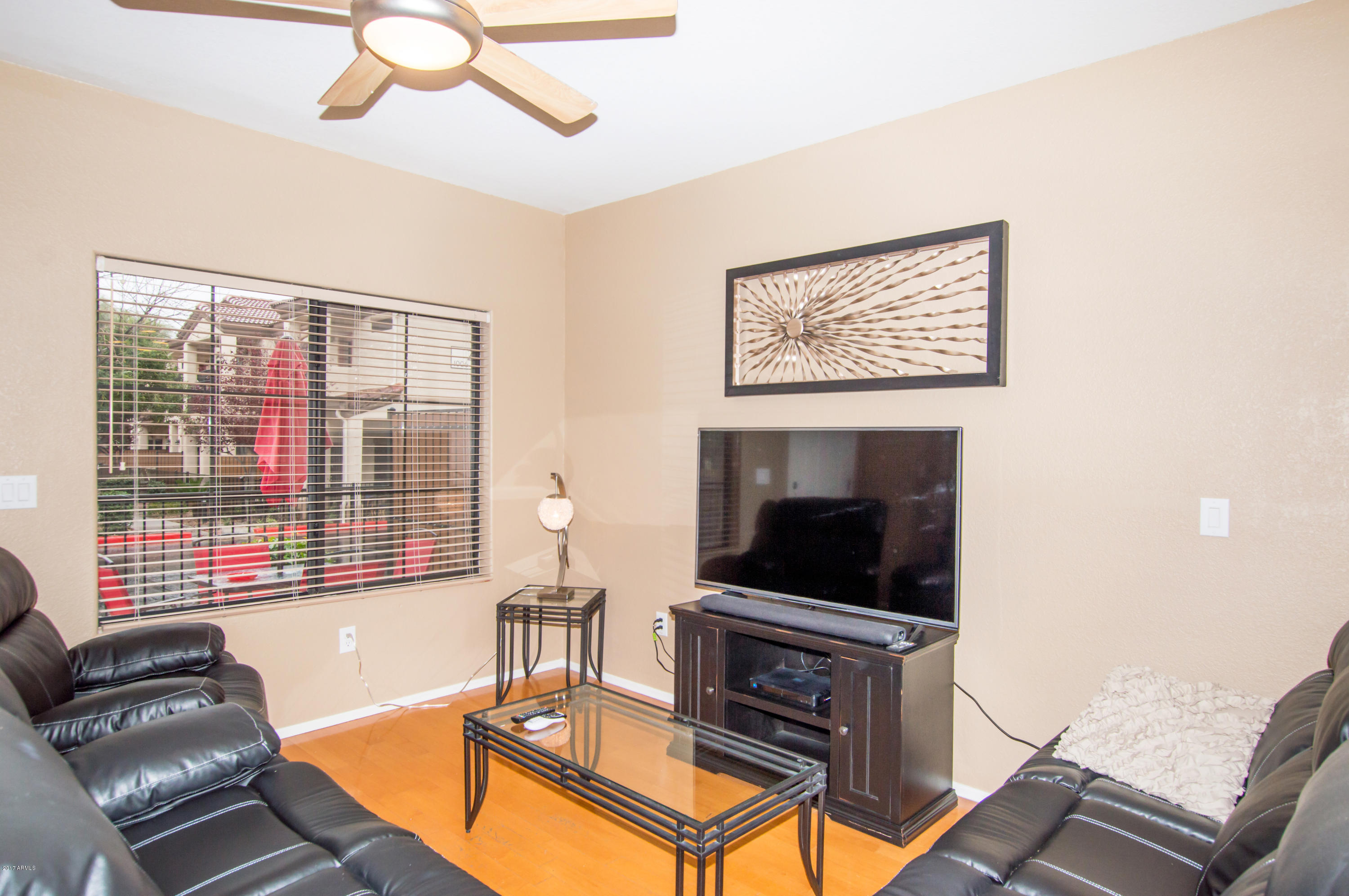 3150 East Beardsley Road, Unit 1016 Phoenix, AZ 85050 - Photo 7 of 25 a living room with furniture a flat screen tv and a fireplace