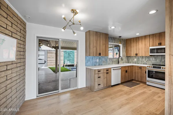 a kitchen with a sink cabinets and stainless steel appliances