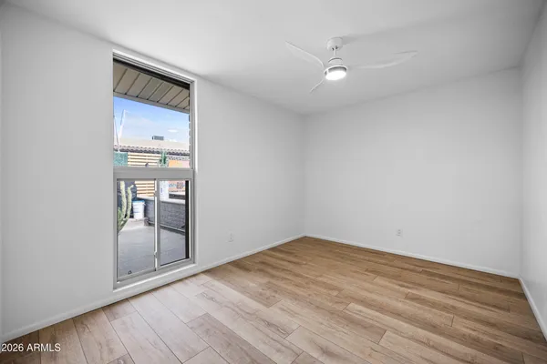 a spacious bedroom with a bed and a potted plant
