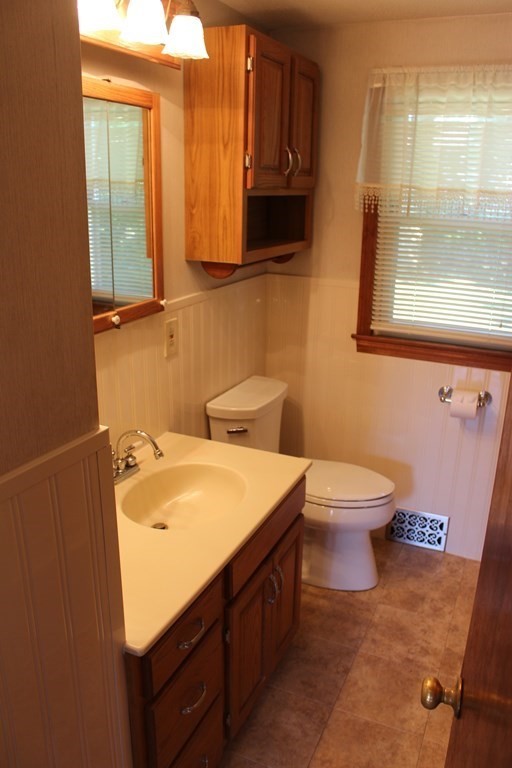 32 Randall Street Chicopee, MA 01013 - Photo 20 of 28 a bathroom with a sink a toilet and mirror