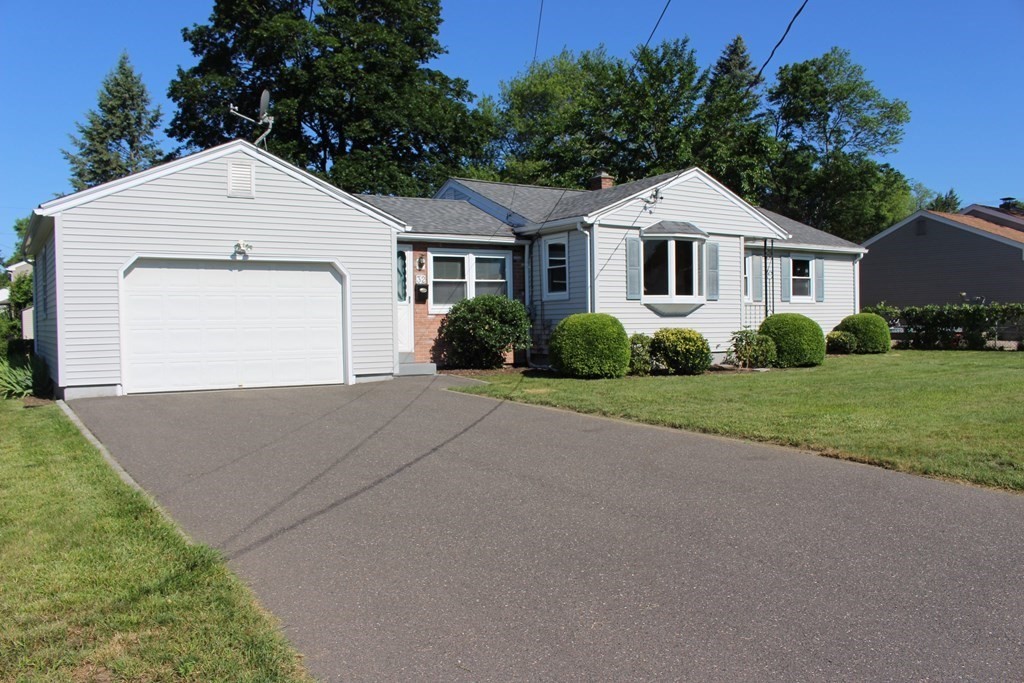 32 Randall Street Chicopee, MA 01013 - Photo 2 of 28 a front view of a house with a yard and garage