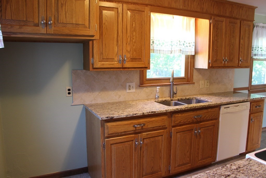 32 Randall Street Chicopee, MA 01013 - Photo 6 of 28 a kitchen with granite countertop cabinets stainless steel appliances a sink and a window